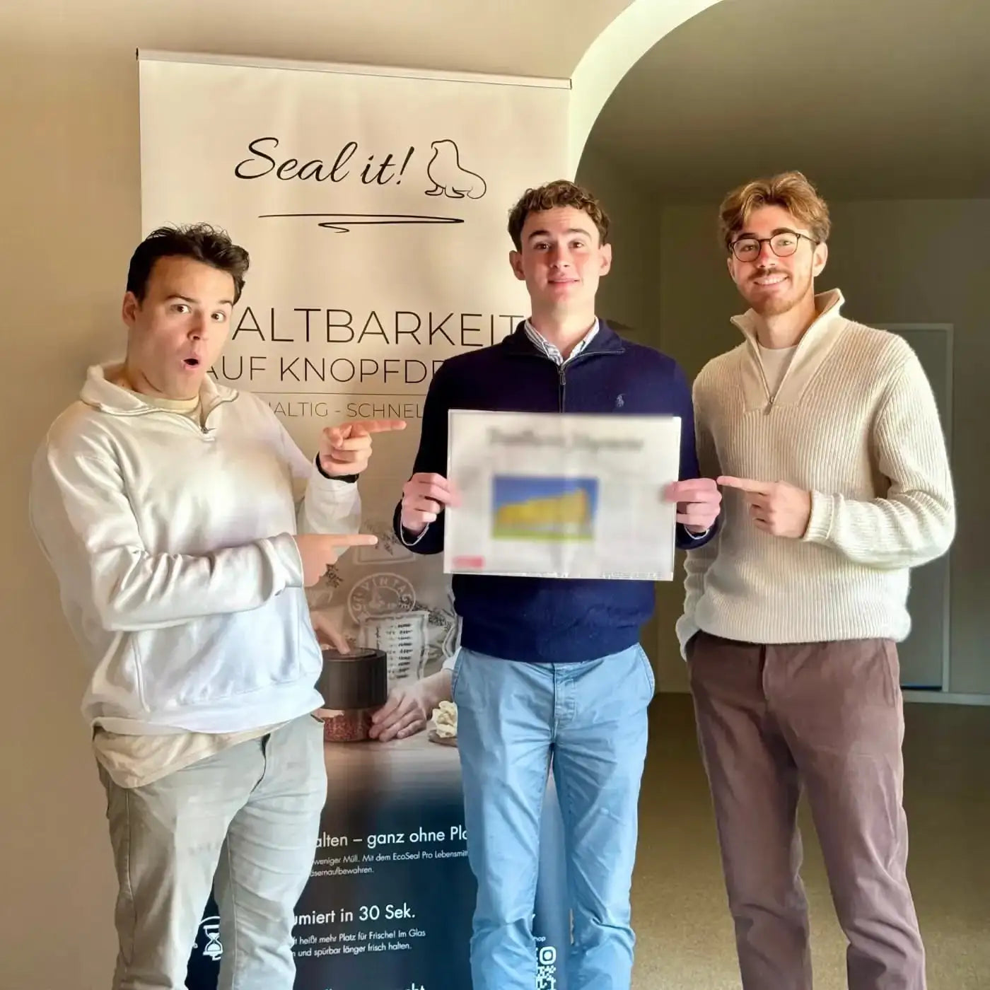 Team holding a newspaper
